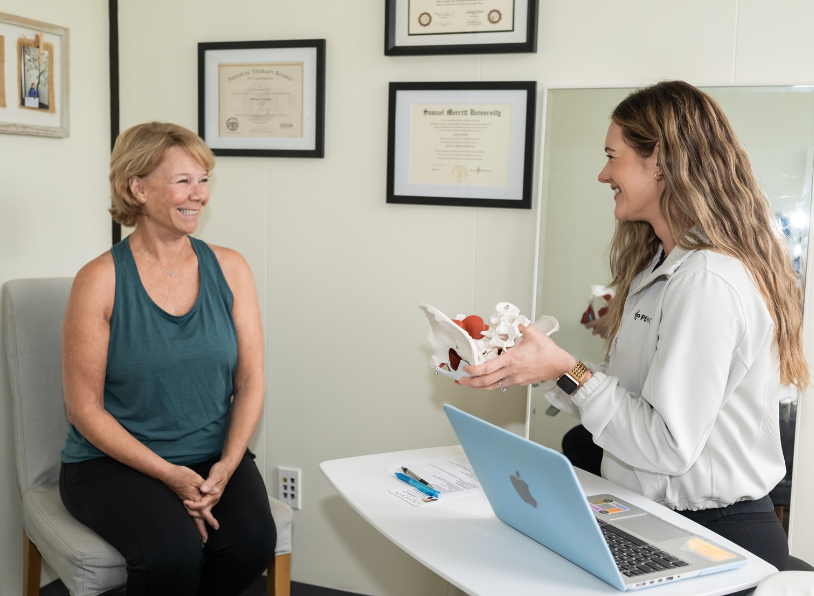 Woman receiving a sample from a healthcare professional in an office setting.